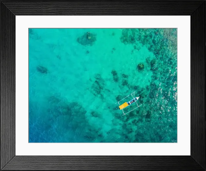 Framed Print : Couple snorkeling in the blue sea ocean and coral background aerial top view