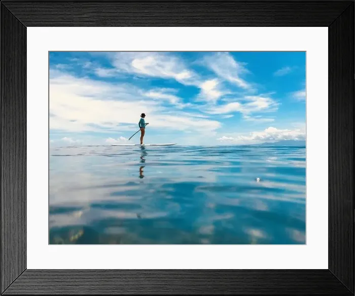 Framed Print : A female stand up paddling. Tavarua Fiji