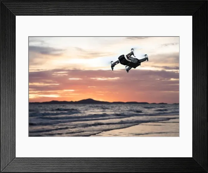 Framed Print : Drone flying against the mountain and sea or ocean at sunset sky Framed Print : Drone flying against the mountain and sea or ocean at sunset sky