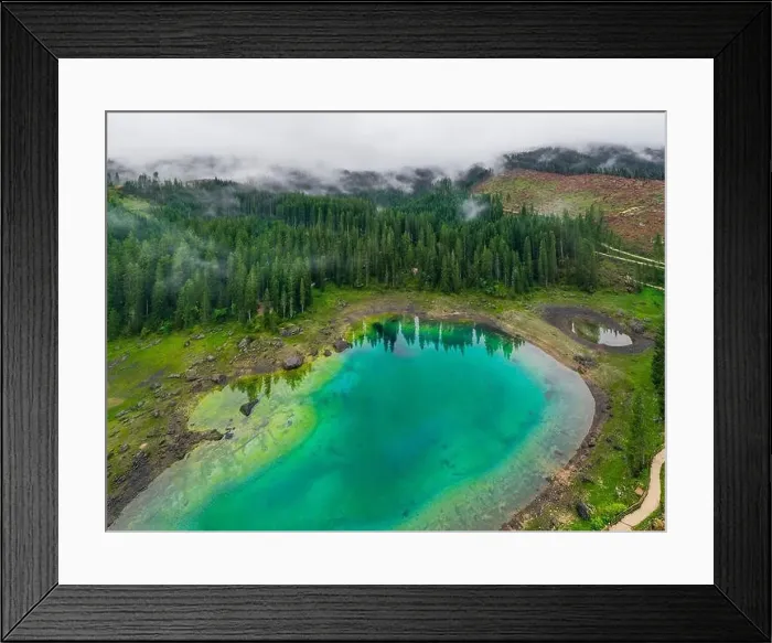Framed Print : Aerial view of turquoise blue water of lake Carezza in Alps Dolomites. Lago di Karersee near fir tree forest Framed Print : Aerial view of turquoise blue water of lake Carezza in Alps Dolomites. Lago di Karersee near fir tree forest