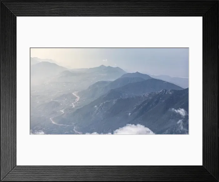 Framed Print : Panorama of beautiful silhouette mountains in blue tones with haze and clouds Framed Print : Panorama of beautiful silhouette mountains in blue tones with haze and clouds