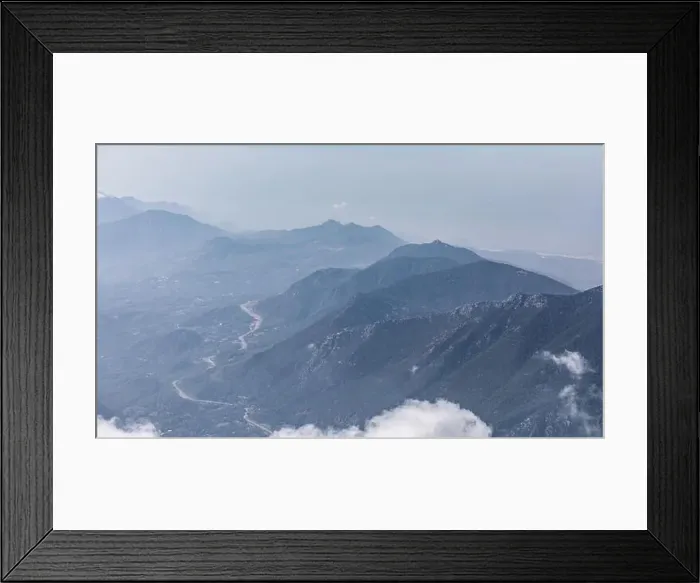 Framed Print : Panorama of beautiful silhouette mountains in blue tones with haze and clouds Framed Print : Panorama of beautiful silhouette mountains in blue tones with haze and clouds