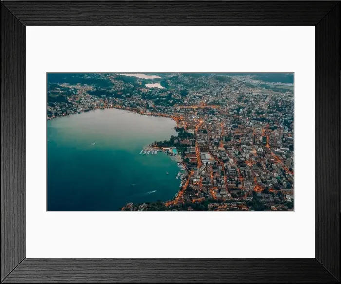 Framed Print : Aerial drone shot view of Lugano city by the lake with street light at dusk after sunset Framed Print : Aerial drone shot view of Lugano city by the lake with street light at dusk after sunset