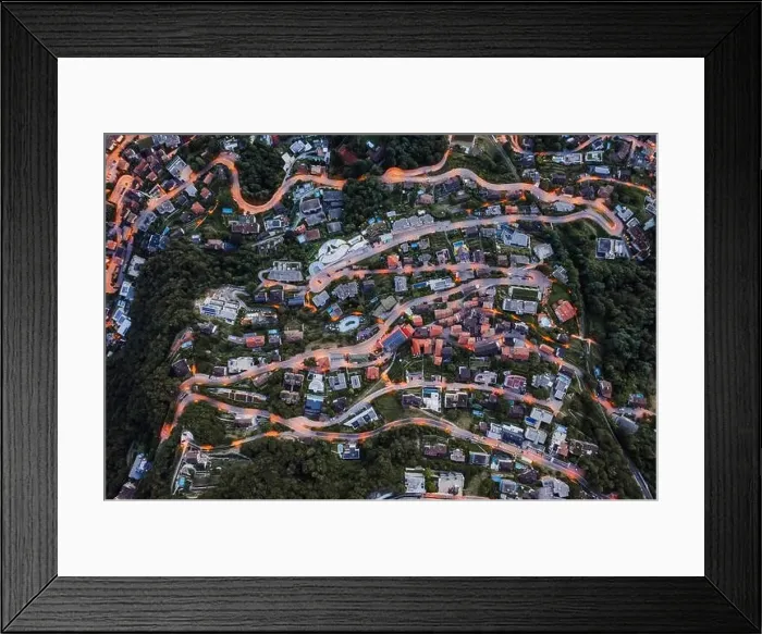 Framed Print : Overhead aerial drone shot view of winding mountain road street light on Monte Bre in Lugano, Switzerland Framed Print : Overhead aerial drone shot view of winding mountain road street light on Monte Bre in Lugano, Switzerland