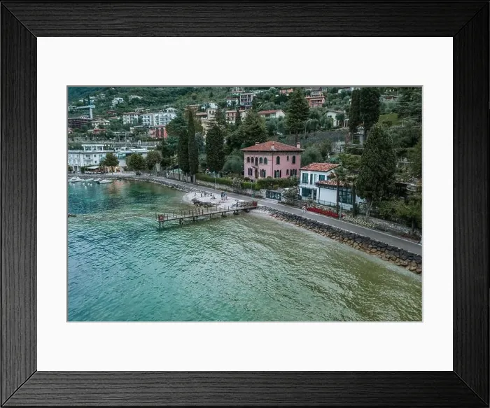Framed Print : Malcesine, Italy - August 7, 2019: Tourists walk on lakeside of Lake Garda Framed Print : Malcesine, Italy - August 7, 2019: Tourists walk on lakeside of Lake Garda