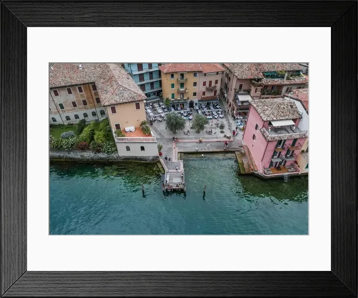 Framed Print : Malcesine, Italy - August 7, 2019: Aerial drone shot of village port in Malcesine Framed Print : Malcesine, Italy - August 7, 2019: Aerial drone shot of village port in Malcesine