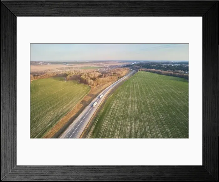 Framed Print : International cargo logistics theme. Truck carry load aerial drone view Framed Print : International cargo logistics theme. Truck carry load aerial drone view