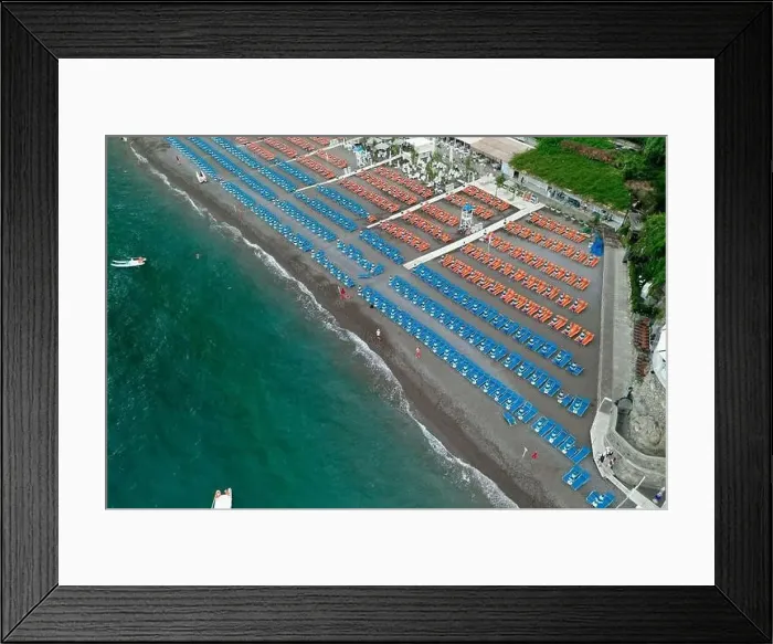 Framed Print : Aerial drone shot view of Positano village and beach with beach umbrella in the morning in Amalfi Coast