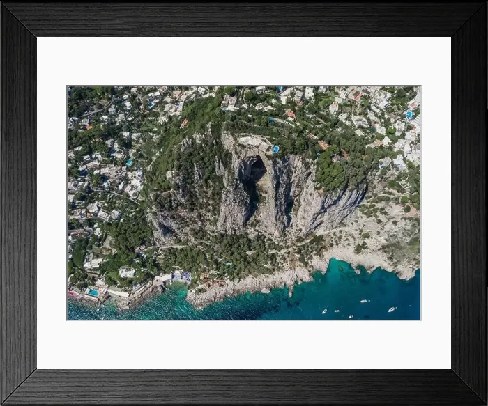 Framed Print : Aerial drone shot of mountain top villa with pool above big mountain hole cave in south Capri Island Framed Print : Aerial drone shot of mountain top villa with pool above big mountain hole cave in south Capri Island