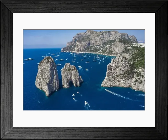 Framed Print : Aerial drone shot view of faraglioni limestone crags in summer in Tyrrhenian sea with yachts off Capri Island Framed Print : Aerial drone shot view of faraglioni limestone crags in summer in Tyrrhenian sea with yachts off Capri Island