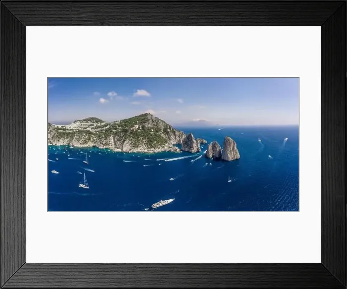 Framed Print : Panoramic view of south Capri Island coastline and faraglioni limestone crags in Tyrrhenian sea Framed Print : Panoramic view of south Capri Island coastline and faraglioni limestone crags in Tyrrhenian sea