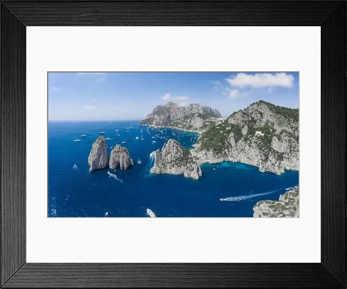 Framed Print : Aerial panoramic view of east Capri Island coastline and faraglioni limestone crags in Tyrrhenian sea Framed Print : Aerial panoramic view of east Capri Island coastline and faraglioni limestone crags in Tyrrhenian sea