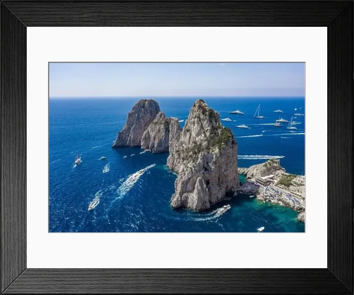 Framed Print : Aerial drone shot view of faraglioni limestone crags in summer time in Tyrrhenian sea off Capri Island Framed Print : Aerial drone shot view of faraglioni limestone crags in summer time in Tyrrhenian sea off Capri Island