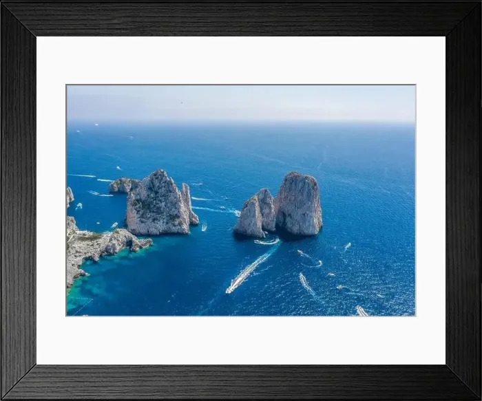Framed Print : Aerial drone shot view of faraglioni limestone crags in summer time in Tyrrhenian sea off Capri Island with yachts Framed Print : Aerial drone shot view of faraglioni limestone crags in summer time in Tyrrhenian sea off Capri Island with yachts