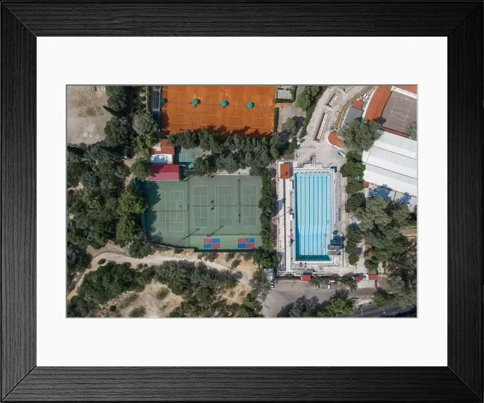 Framed Print : Aerial overhead drone shot of hard and clay tennis court besides swimming pool in Athens Framed Print : Aerial overhead drone shot of hard and clay tennis court besides swimming pool in Athens
