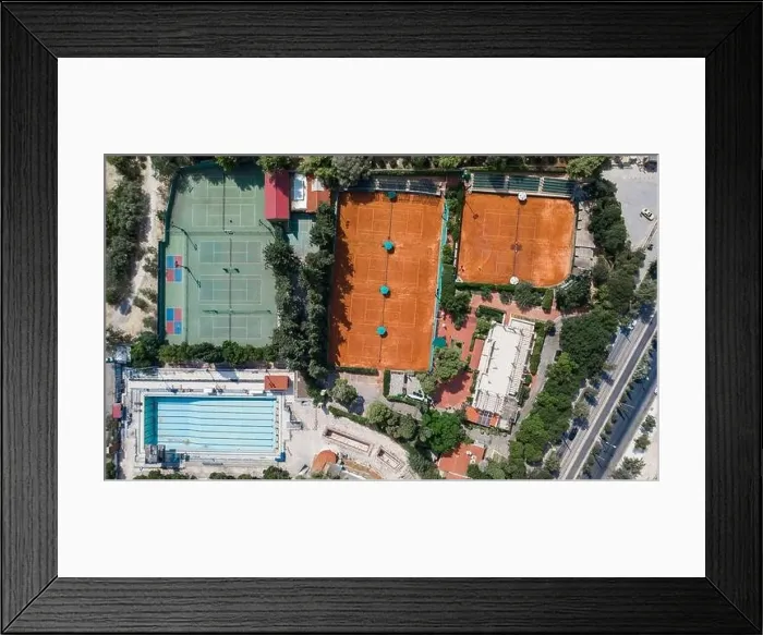 Framed Print : Aerial overhead drone shot of hard and clay tennis court besides swimming pool in Athens Framed Print : Aerial overhead drone shot of hard and clay tennis court besides swimming pool in Athens