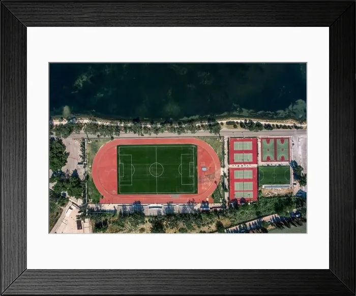 Framed Print : Aerial overhead drone shot of football field, tennis and basketball court in Argostolion, on Kefalonia Island Framed Print : Aerial overhead drone shot of football field, tennis and basketball court in Argostolion, on Kefalonia Island