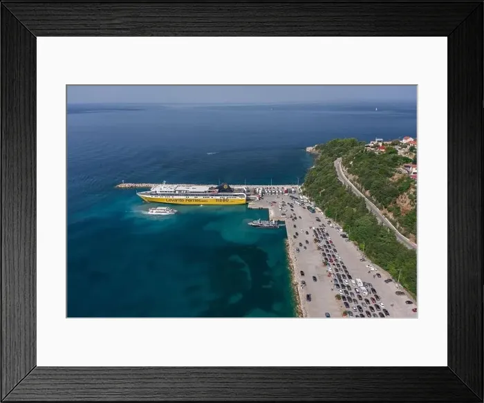 Framed Print : Kefalonia, Greece - August 22, 2019: Aerial drone shot of cars in queue for embarkement in cruise ship in Poros Framed Print : Kefalonia, Greece - August 22, 2019: Aerial drone shot of cars in queue for embarkement in cruise ship in Poros