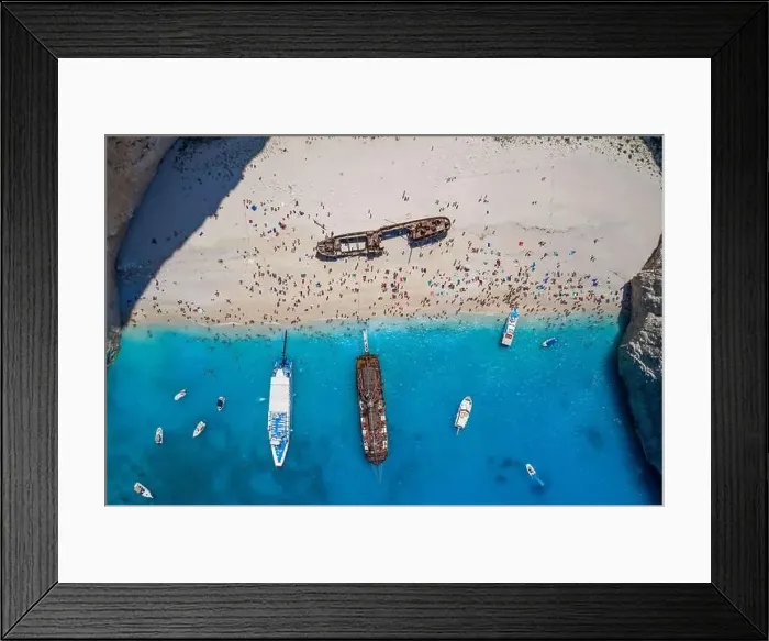 Framed Print : Aerial overhead drone shot of Zakynthos Navagio beach full of tourists and cruise ship in Ionian sea in Greece Framed Print : Aerial overhead drone shot of Zakynthos Navagio beach full of tourists and cruise ship in Ionian sea in Greece