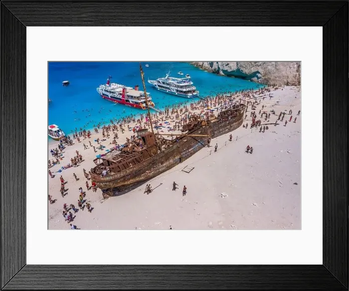 Framed Print : Zakynthos, Greece - August 20, 2019: Tourists enjoy summer time by abandoned rusty ship on shipwreck navagio beach Framed Print : Zakynthos, Greece - August 20, 2019: Tourists enjoy summer time by abandoned rusty ship on shipwreck navagio beach