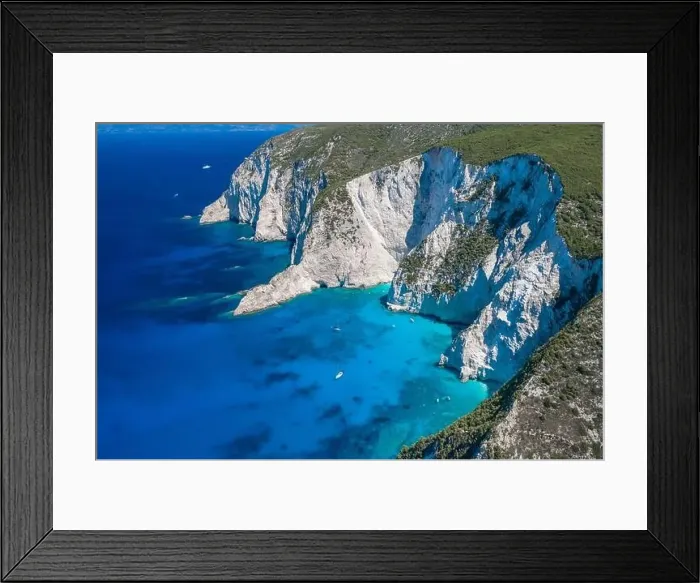Framed Print : Aerial drone shot of Zakynthos Navagio beach cliffs by blue Ionian sea in summer Framed Print : Aerial drone shot of Zakynthos Navagio beach cliffs by blue Ionian sea in summer