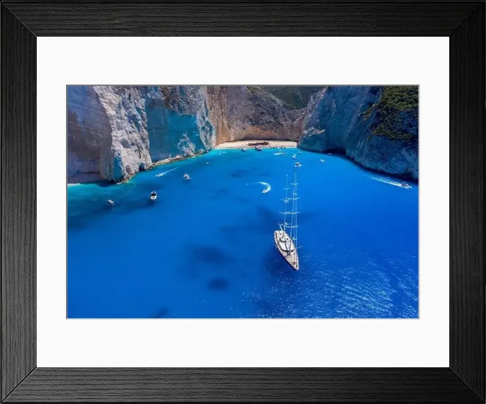 Framed Print : Aerial drone shot of luxury yacht leaving Zakynthos shipwreck navagio beach in summer Framed Print : Aerial drone shot of luxury yacht leaving Zakynthos shipwreck navagio beach in summer
