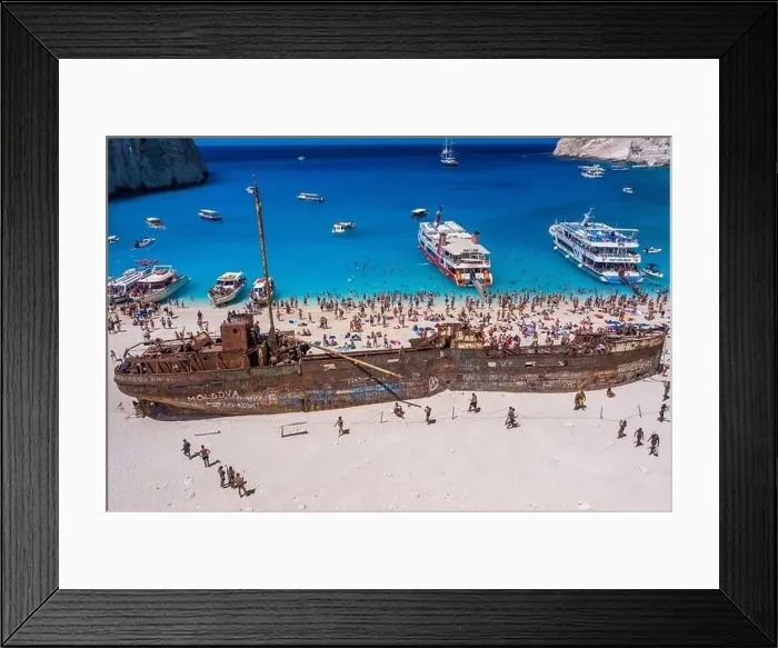 Framed Print : Zakynthos, Greece - August 20, 2019: Tourists enjoy summer time by abandoned rusty ship on shipwreck navagio beach Framed Print : Zakynthos, Greece - August 20, 2019: Tourists enjoy summer time by abandoned rusty ship on shipwreck navagio beach