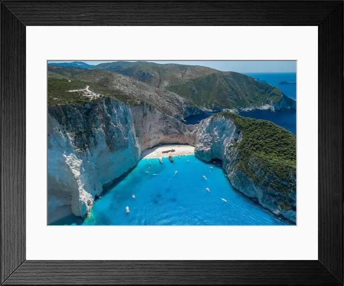 Framed Print : Aerial drone shot of Zakynthos Navagio beach with tourists with cruise ship in blue Ionnian sea Framed Print : Aerial drone shot of Zakynthos Navagio beach with tourists with cruise ship in blue Ionnian sea