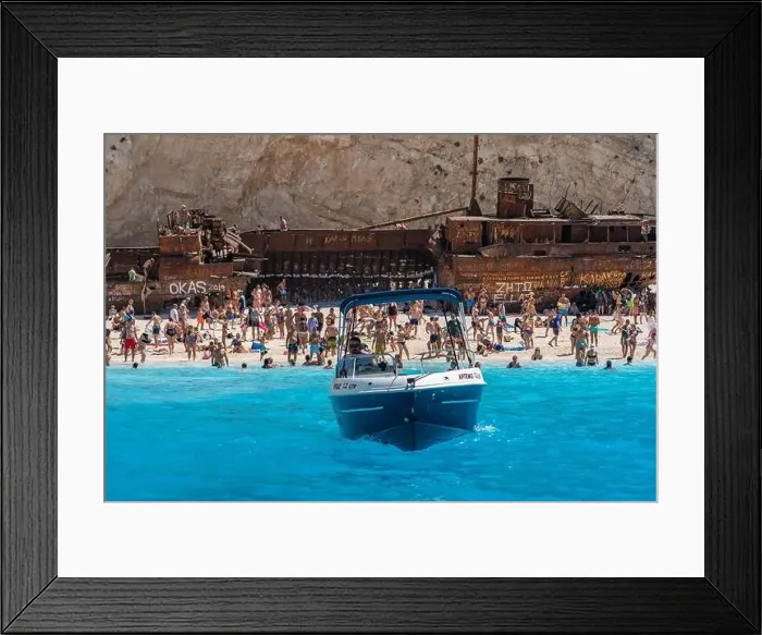Framed Print : Zakynthos, Greece - August 20, 2019: speed boat leaves shipwreck navagio beach in summer Framed Print : Zakynthos, Greece - August 20, 2019: speed boat leaves shipwreck navagio beach in summer