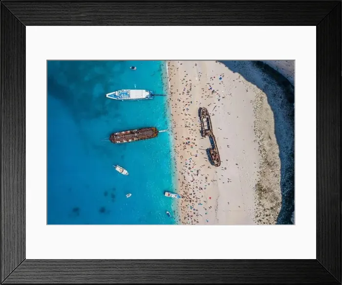 Framed Print : Aerial overhead drone shot of Zakynthos Navagio beach full of tourists and cruise ship in Ionian sea in Greece