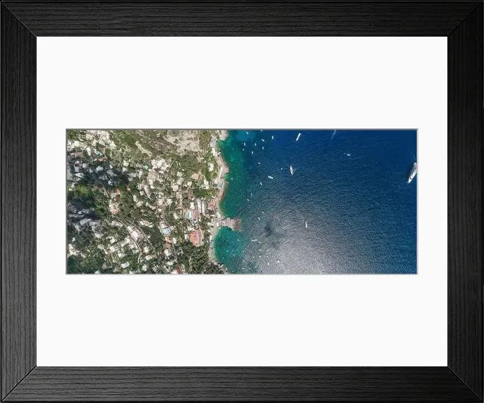 Framed Print : Aerial overhead drone panoramic shot of southern Capri Island coastline with yachts in summer noon Framed Print : Aerial overhead drone panoramic shot of southern Capri Island coastline with yachts in summer noon