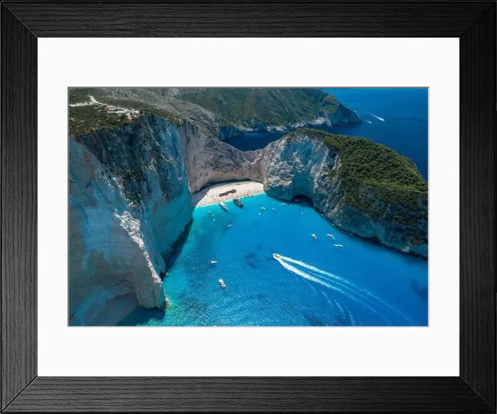 Framed Print : Aerial drone shot of Zakynthos Navagio beach with tourists with cruise ship in blue Ionnian sea Framed Print : Aerial drone shot of Zakynthos Navagio beach with tourists with cruise ship in blue Ionnian sea