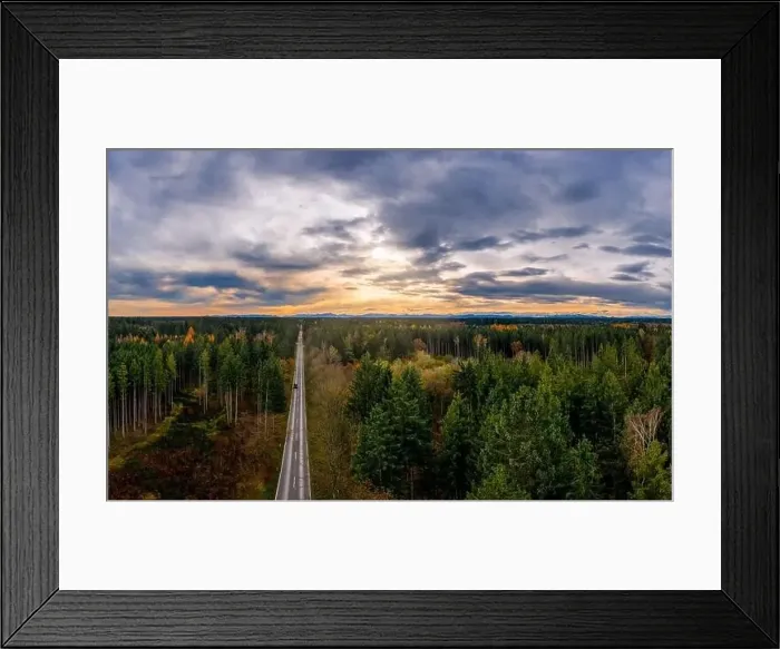 Framed Print : Aerial view of road among the forest and trees. Sunset field in southern germany near the alps Framed Print : Aerial view of road among the forest and trees. Sunset field in southern germany near the alps