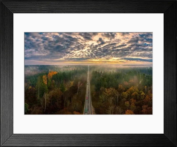 Framed Print : The beautiful view over a road framed by autumn colored trees with view to the mountains in background Framed Print : The beautiful view over a road framed by autumn colored trees with view to the mountains in background