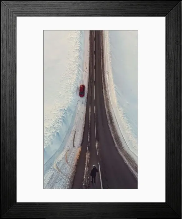 Framed Print : Surreal image with an unusual perspective with a woman on a winter road and car Framed Print : Surreal image with an unusual perspective with a woman on a winter road and car