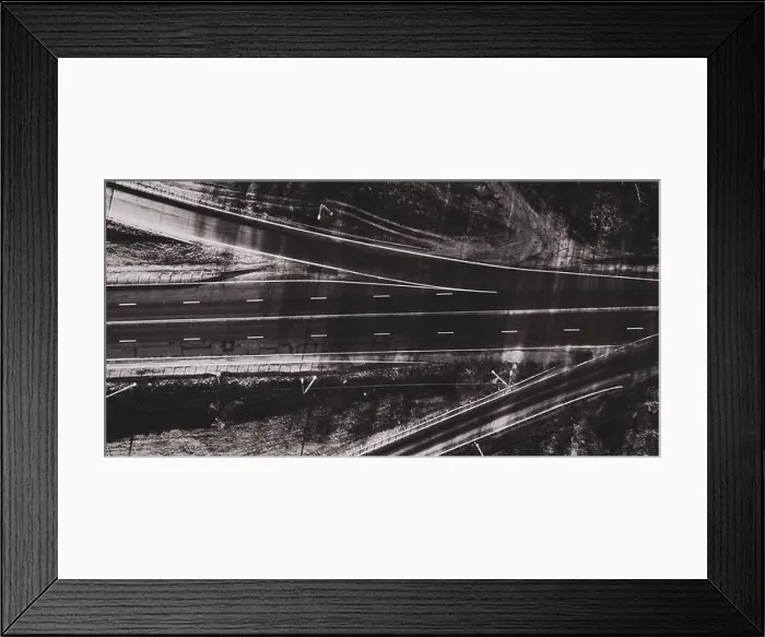 Framed Print : Drone view of black and white morning empty country side road with beautiful green landscape around Framed Print : Drone view of black and white morning empty country side road with beautiful green landscape around