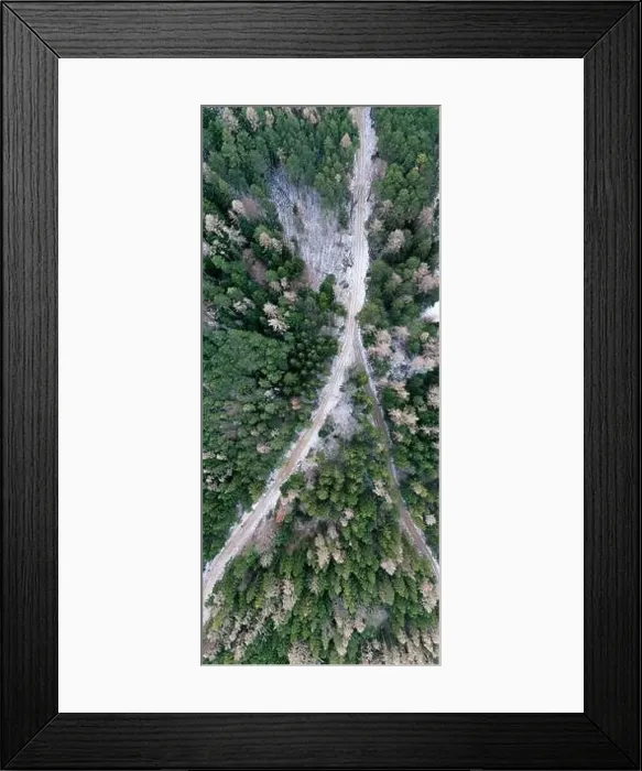 Framed Print : Aerial view of snowy winter forest with a road in austria Framed Print : Aerial view of snowy winter forest with a road in austria