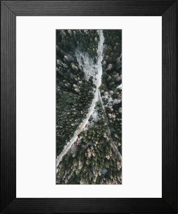 Framed Print : Aerial view of snowy winter forest with a road in austria Framed Print : Aerial view of snowy winter forest with a road in austria