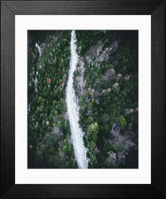 Framed Print : Aerial view of snowy winter forest with a road in austria Framed Print : Aerial view of snowy winter forest with a road in austria