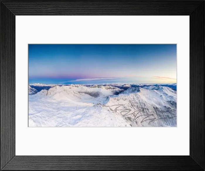 Framed Print : Pano by drone of sunrise over the narrow bends of Stelvio Pass mountain road covered with snow Framed Print : Pano by drone of sunrise over the narrow bends of Stelvio Pass mountain road covered with snow