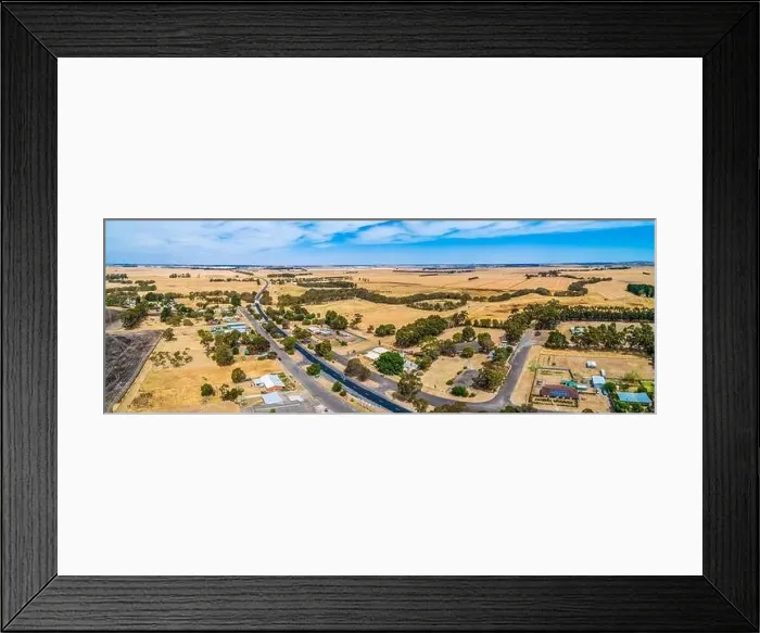 Framed Print : Wide aerial panoramic landscape of rural road passing through small township of Streatham in Victoria, Australia Framed Print : Wide aerial panoramic landscape of rural road passing through small township of Streatham in Victoria, Australia