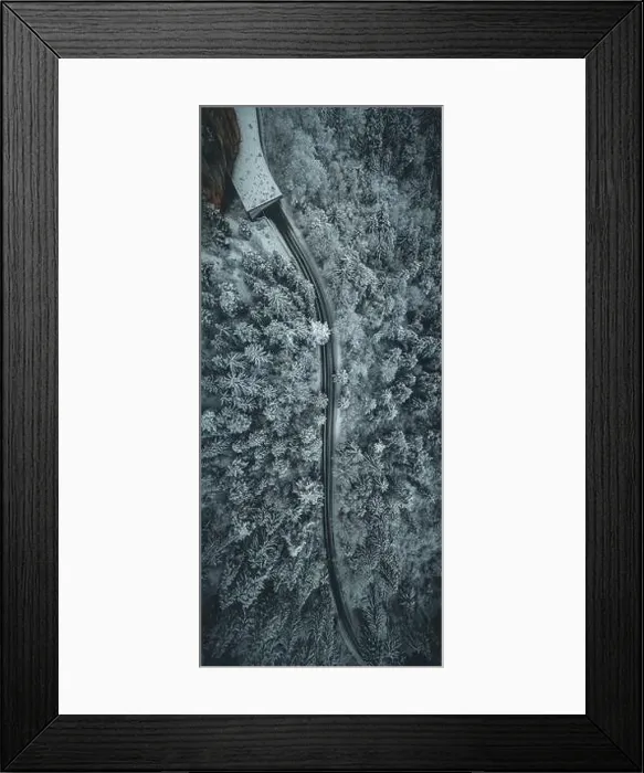 Framed Print : Aerial view of snowy forest with a road. Captured from above with a drone Framed Print : Aerial view of snowy forest with a road. Captured from above with a drone