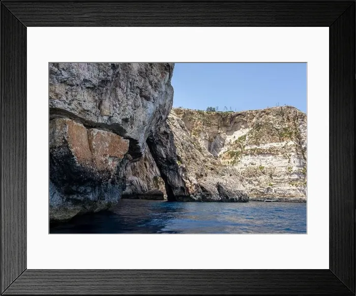 Framed Print : rocks in the sea. Mountain slopes on the background of the sea shore Framed Print : rocks in the sea. Mountain slopes on the background of the sea shore