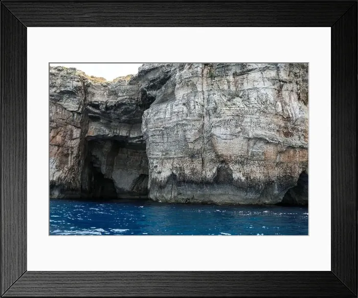 Framed Print : rocks in the sea. Mountain slopes on the background of the sea shore Framed Print : rocks in the sea. Mountain slopes on the background of the sea shore