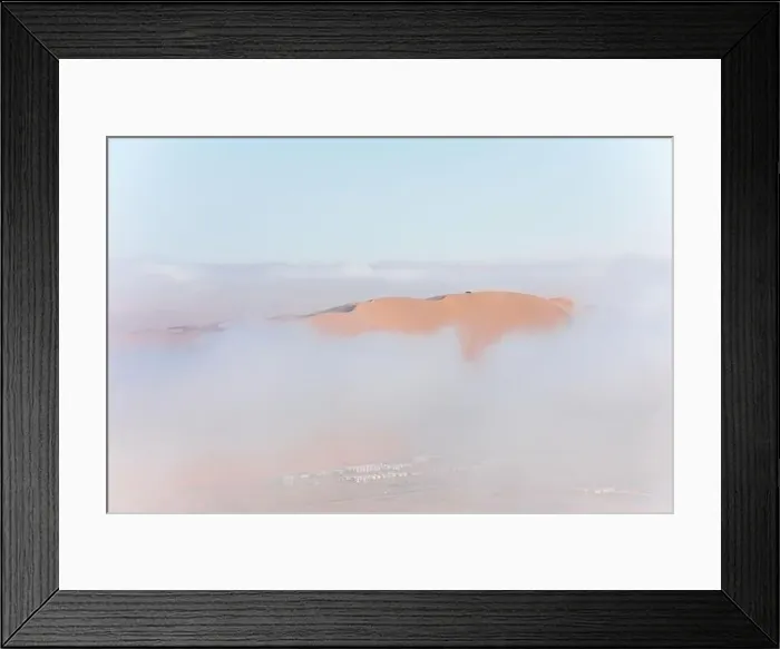 Framed Print : Top of a massive sand dune emerging from a thick cloud of fog after sunrise Framed Print : Top of a massive sand dune emerging from a thick cloud of fog after sunrise