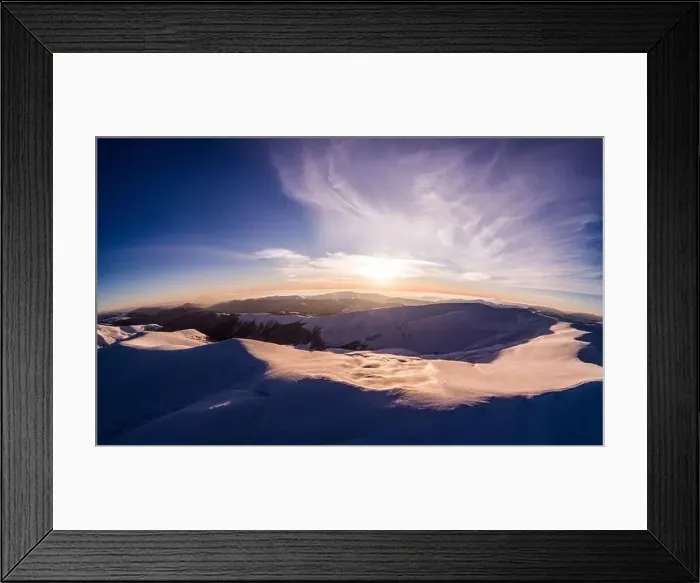 Framed Print : Fabulous evening panorama with snow-capped mountains and hills with bright sun and fog on a frosty winter evening Framed Print : Fabulous evening panorama with snow-capped mountains and hills with bright sun and fog on a frosty winter evening