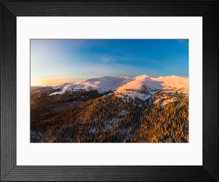 Framed Print : Top view of a magical view of a mountain winter forest with thick fir trees and hills in a beautiful pink winter sunset Framed Print : Top view of a magical view of a mountain winter forest with thick fir trees and hills in a beautiful pink winter sunset