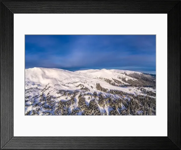 Framed Print : Aerial view of beautiful winter mountain slopes covered with snow and firs forest on a sunny cloudless day Framed Print : Aerial view of beautiful winter mountain slopes covered with snow and firs forest on a sunny cloudless day