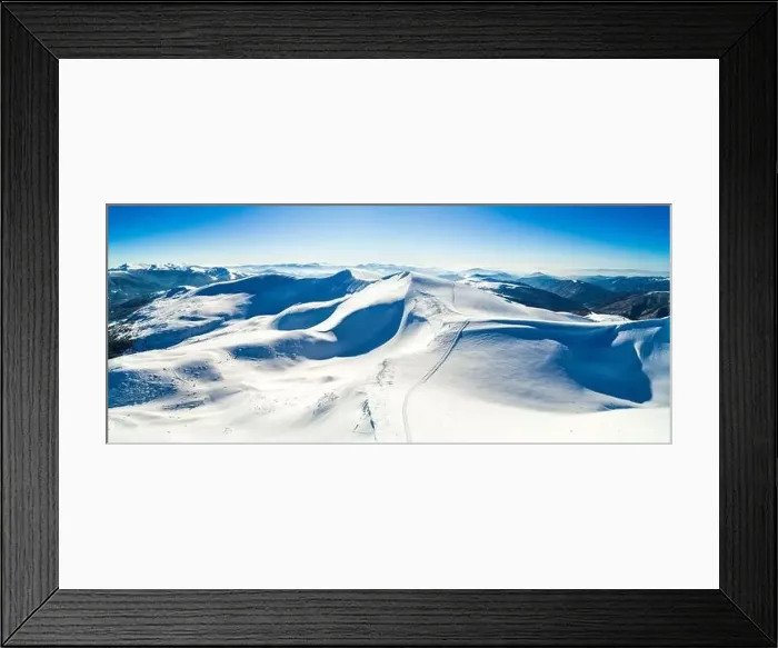 Framed Print : Aerial view of a stunning snowy ski resort with snowy hills in the mountains and tourist site on a sunny clear morning Framed Print : Aerial view of a stunning snowy ski resort with snowy hills in the mountains and tourist site on a sunny clear morning