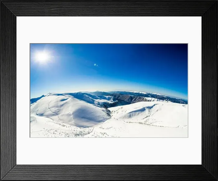 Framed Print : Aerial view of an amazing mesmerizing view of a mountain winter landscape on a sunny frosty day at a ski resort Framed Print : Aerial view of an amazing mesmerizing view of a mountain winter landscape on a sunny frosty day at a ski resort